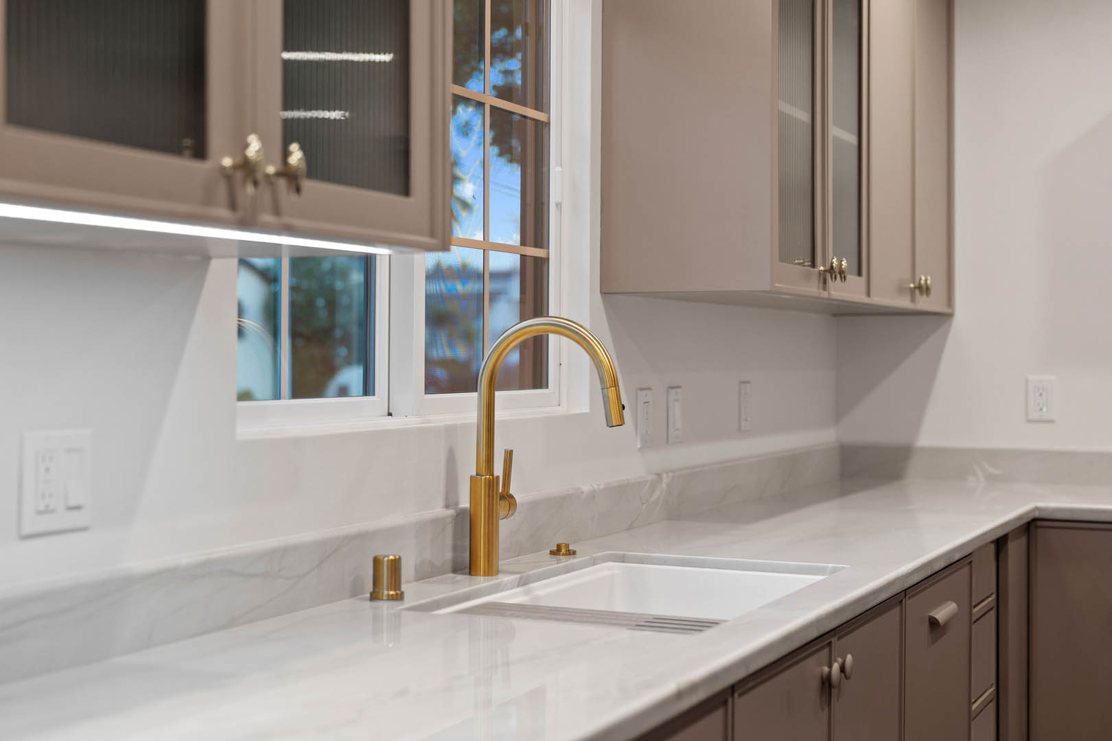 Sink next to window and cabinets