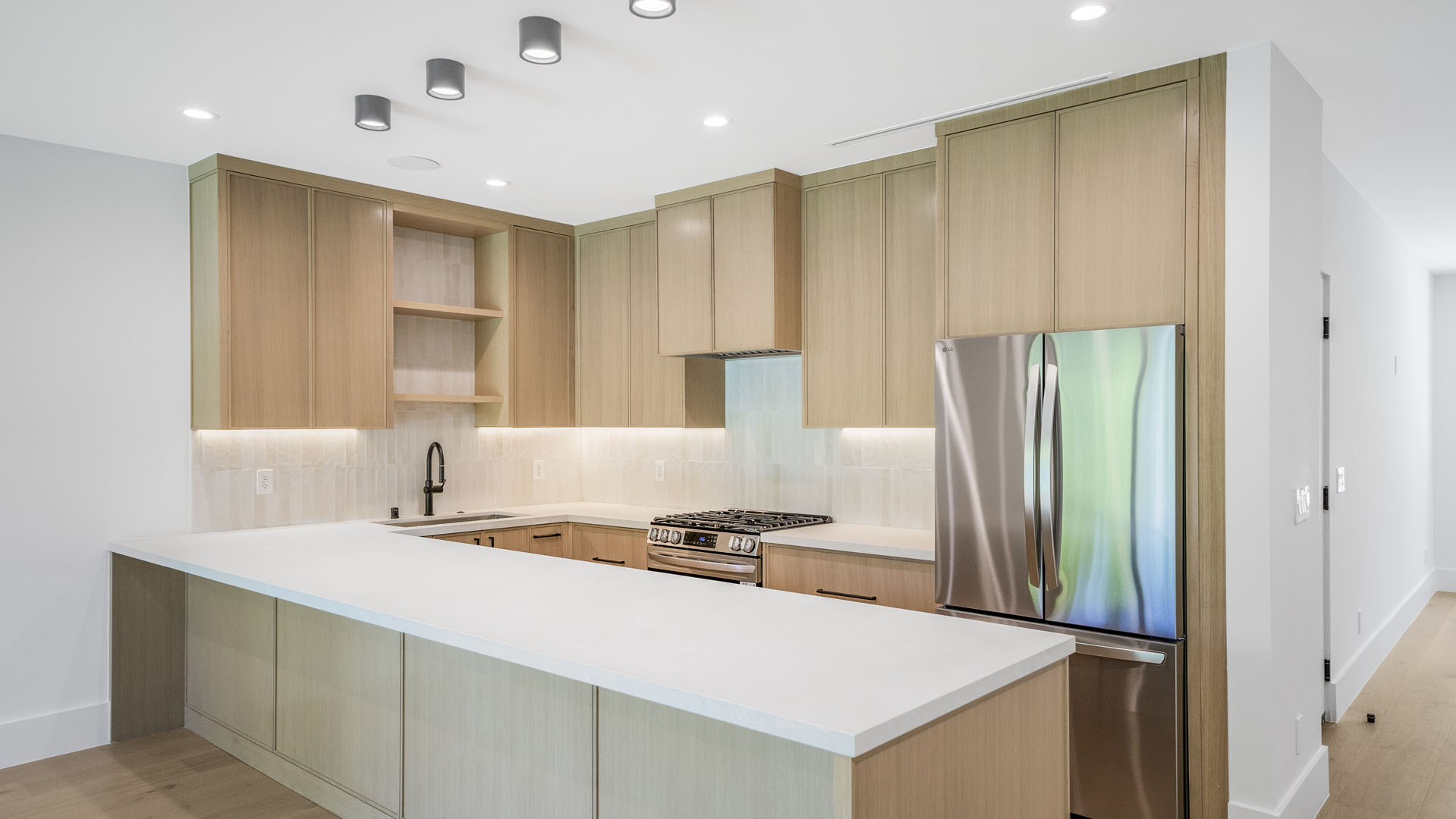 Kitchen with cabinets and a gray refrigerator